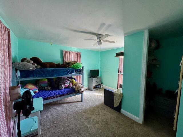 carpeted bedroom featuring ceiling fan