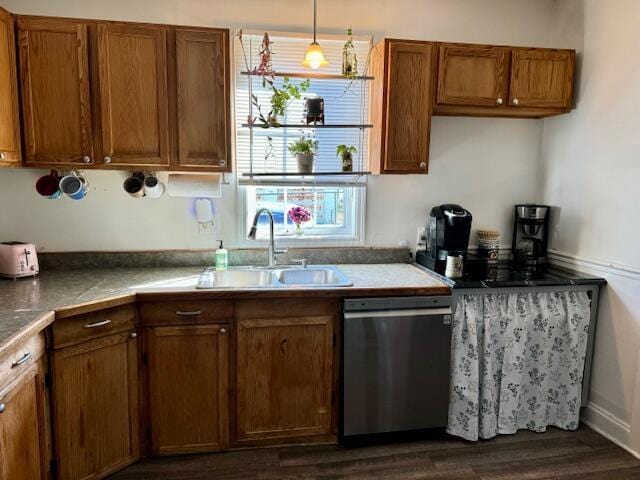 kitchen with dark hardwood / wood-style flooring, dishwasher, decorative light fixtures, and sink