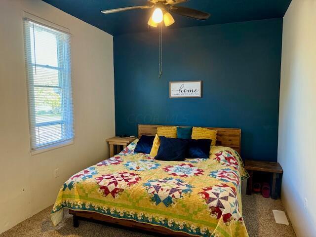 carpeted bedroom with ceiling fan