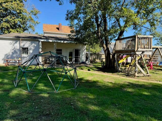 rear view of property with a lawn