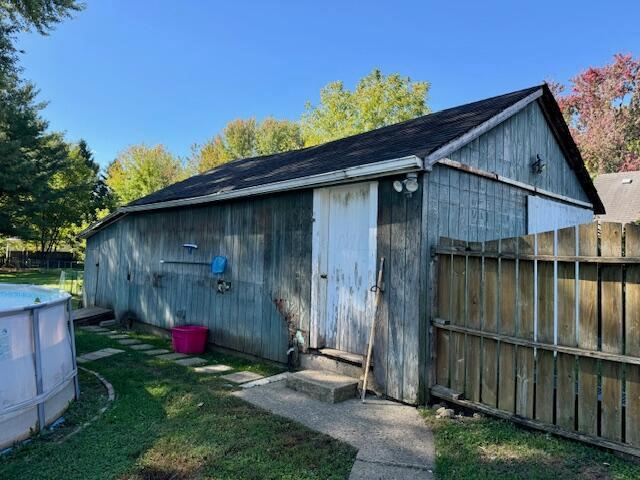 view of outbuilding featuring a yard