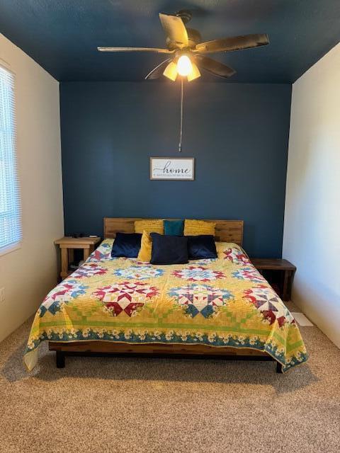 bedroom with ceiling fan and carpet