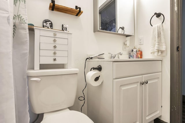 bathroom featuring vanity and toilet