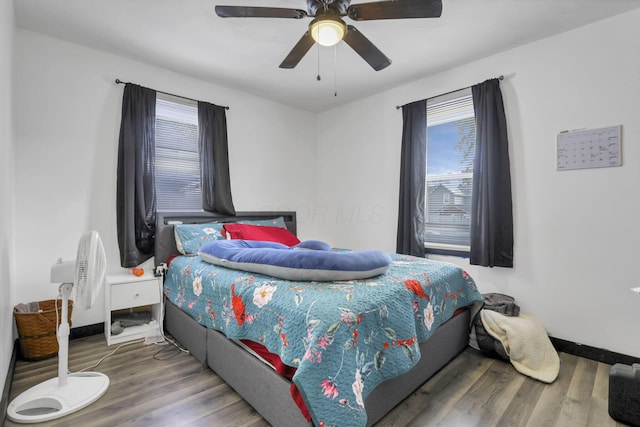 bedroom with wood-type flooring and ceiling fan