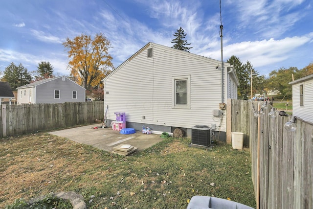 rear view of house with a lawn, a patio, and central AC unit