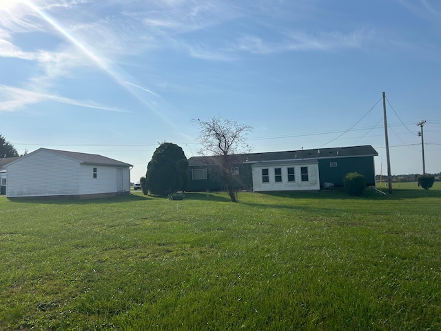 rear view of property with a yard