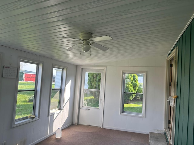 unfurnished sunroom with vaulted ceiling and ceiling fan