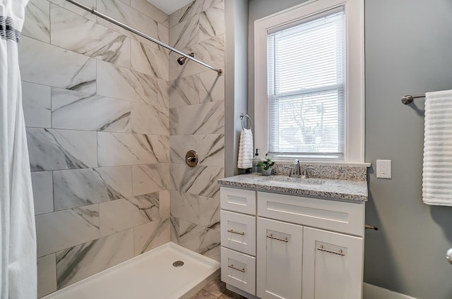 bathroom featuring plenty of natural light, vanity, and a shower with shower curtain