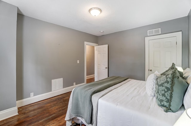 bedroom with dark wood-type flooring