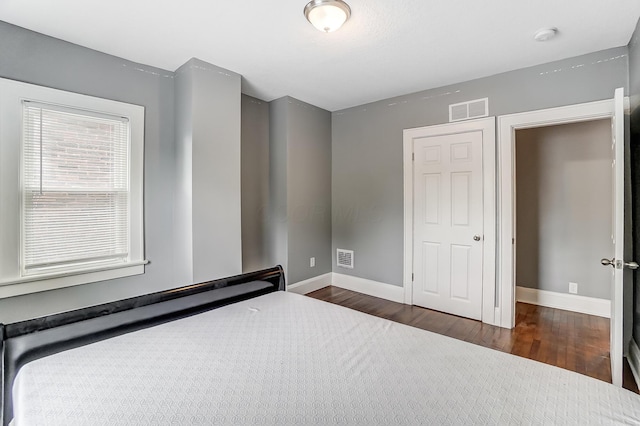 unfurnished bedroom with dark hardwood / wood-style floors