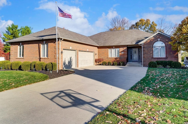 ranch-style house featuring a garage and a front lawn