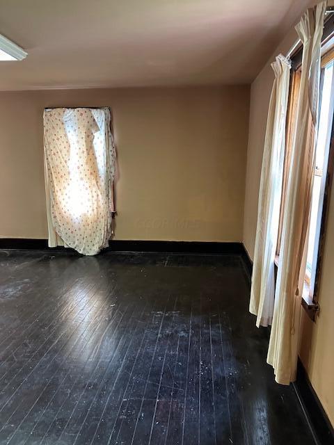 spare room featuring dark hardwood / wood-style flooring