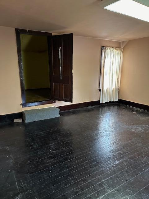 empty room featuring wood-type flooring