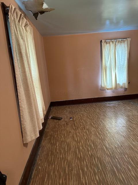 spare room featuring dark wood-type flooring