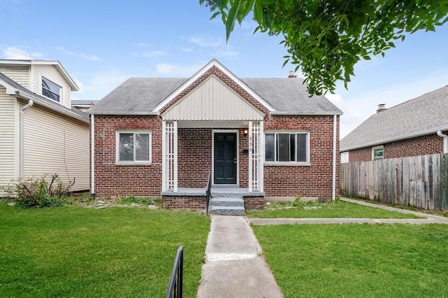 bungalow-style house featuring a front lawn