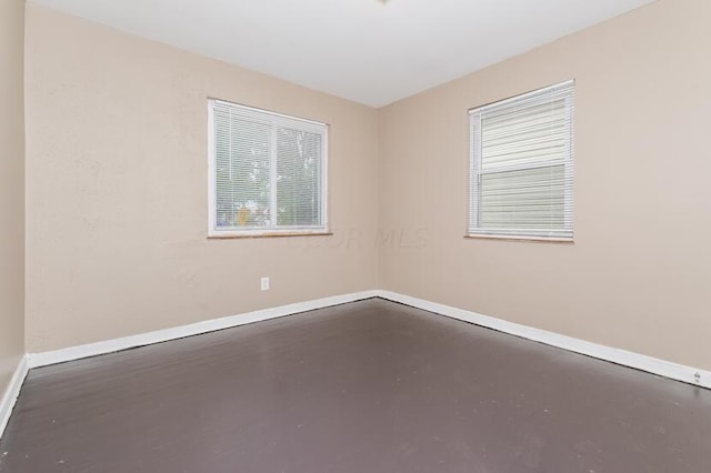 empty room with concrete flooring