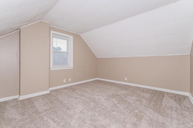 bonus room featuring carpet flooring and lofted ceiling