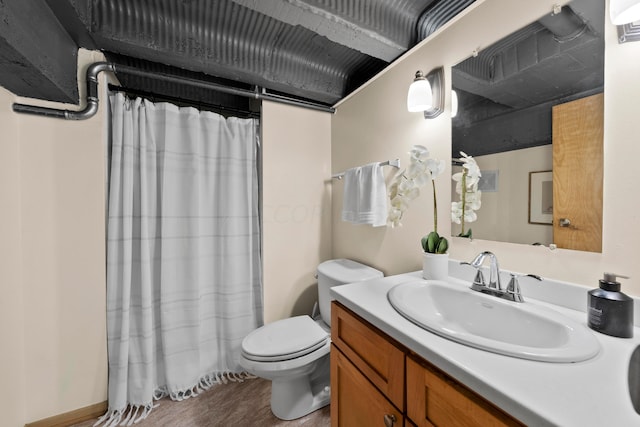 bathroom featuring hardwood / wood-style flooring, vanity, toilet, and a shower with shower curtain