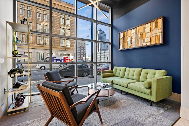 interior space with a high ceiling, floor to ceiling windows, and carpet