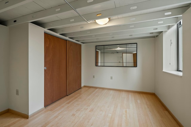 interior space with beam ceiling and light wood-type flooring