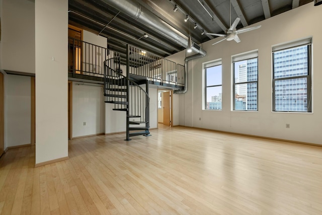 basement with ceiling fan and light hardwood / wood-style flooring