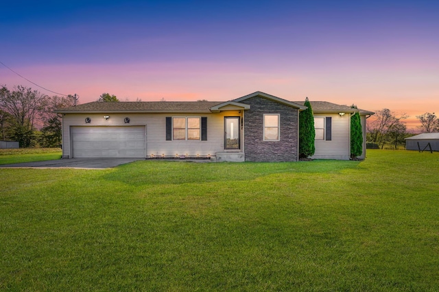 ranch-style house with a lawn and a garage