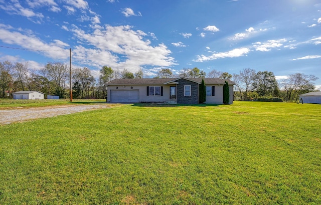 single story home featuring a front lawn and a garage