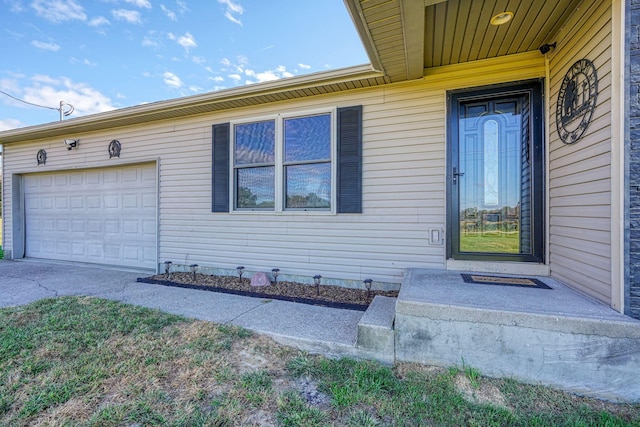 view of exterior entry with a garage