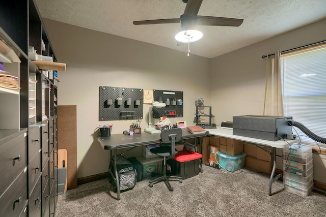 carpeted office space featuring ceiling fan and a textured ceiling