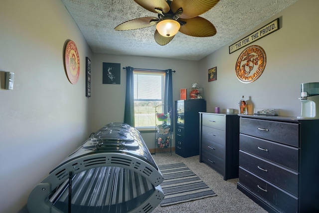 bedroom featuring ceiling fan, a textured ceiling, and light carpet