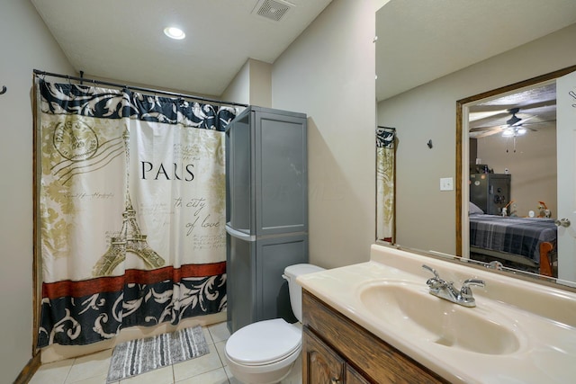 bathroom with tile patterned floors, vanity, ceiling fan, and toilet