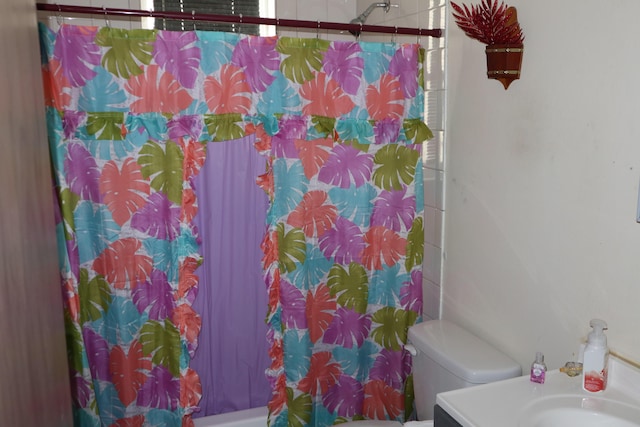 full bathroom featuring shower / bath combination with curtain, vanity, and toilet