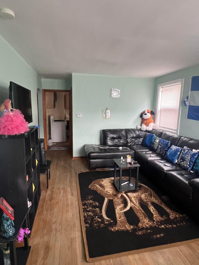 living room with washer / clothes dryer and hardwood / wood-style floors