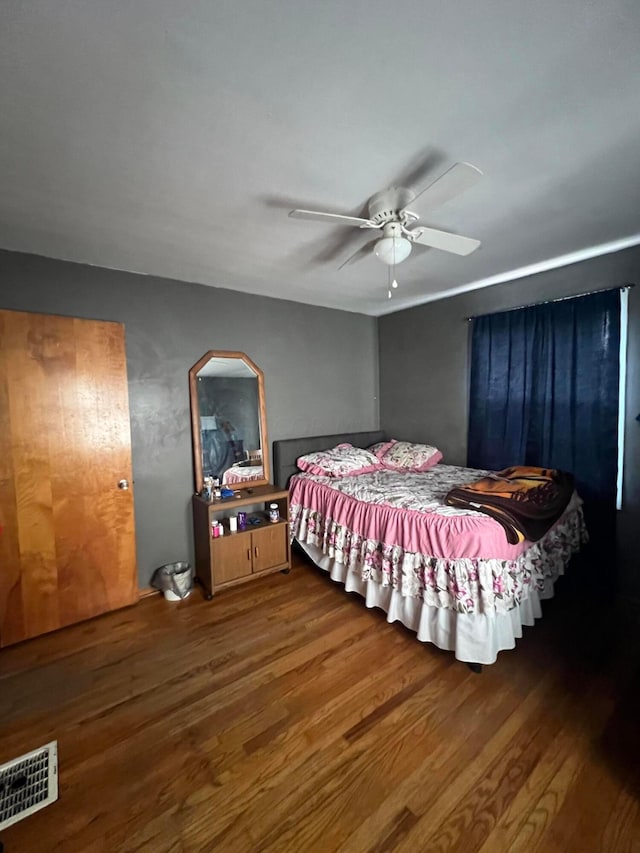 bedroom with hardwood / wood-style floors and ceiling fan