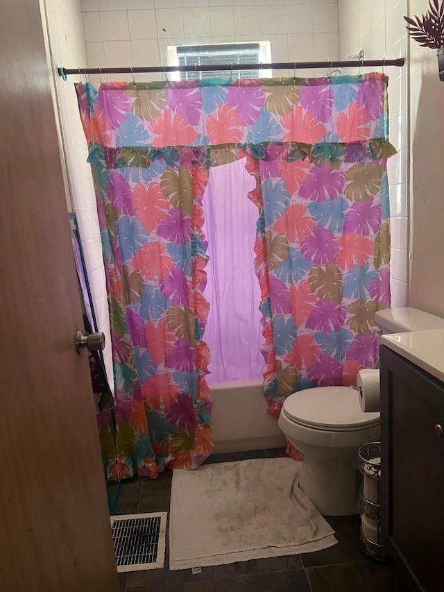 full bathroom featuring tile patterned floors, shower / bath combo, toilet, and vanity