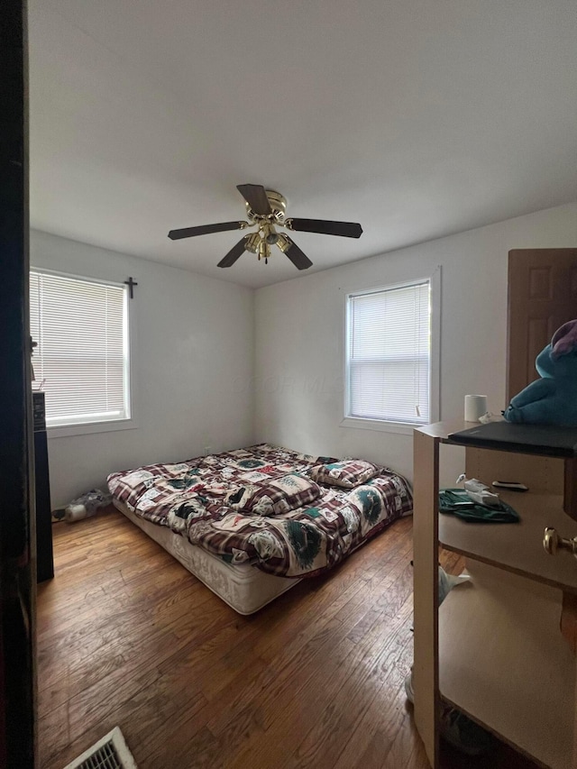 bedroom with hardwood / wood-style floors and ceiling fan