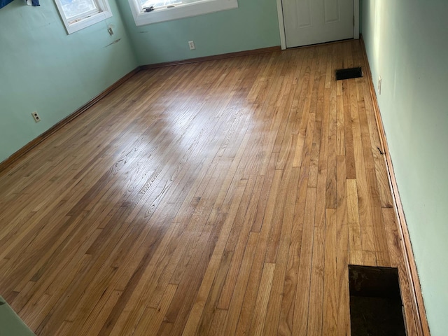 spare room with light hardwood / wood-style floors