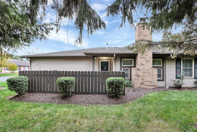 rear view of house with a yard