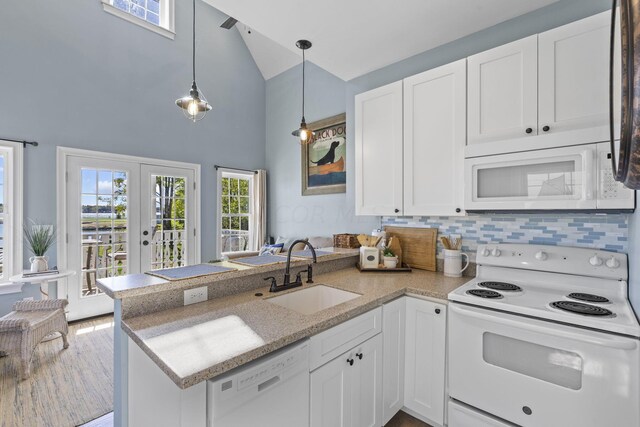 kitchen featuring kitchen peninsula, sink, white cabinets, and white appliances