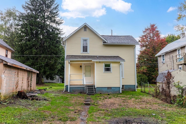 rear view of property with a lawn