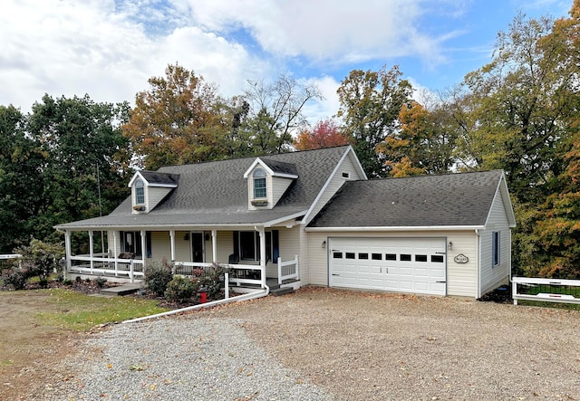 new england style home with a garage and covered porch