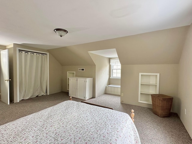 carpeted bedroom featuring lofted ceiling