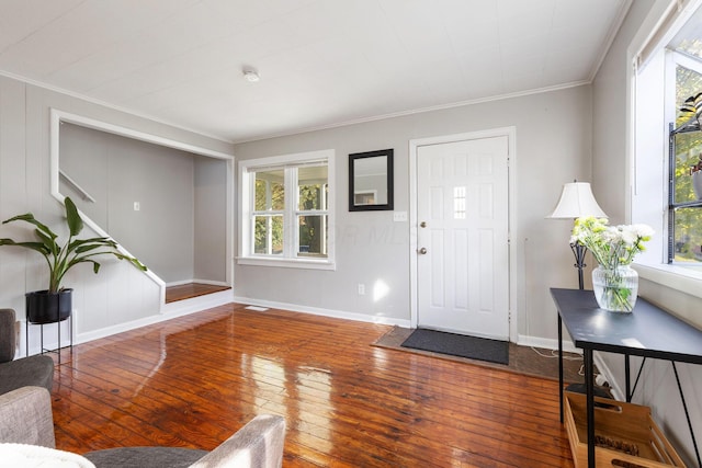 entryway with crown molding and wood-type flooring