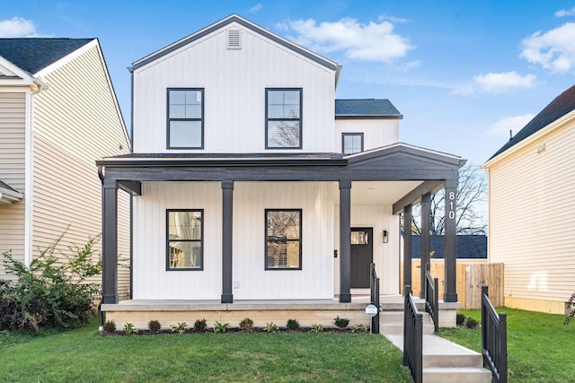 modern inspired farmhouse with covered porch and a front yard