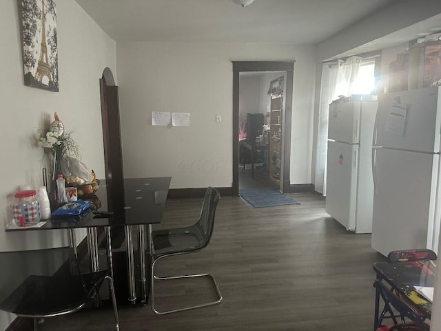 dining area with dark hardwood / wood-style flooring