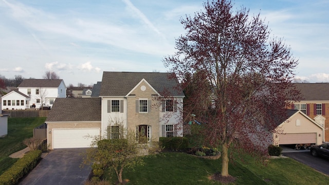 view of front of property with a front lawn and a garage