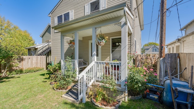 view of front of property with covered porch and a front yard