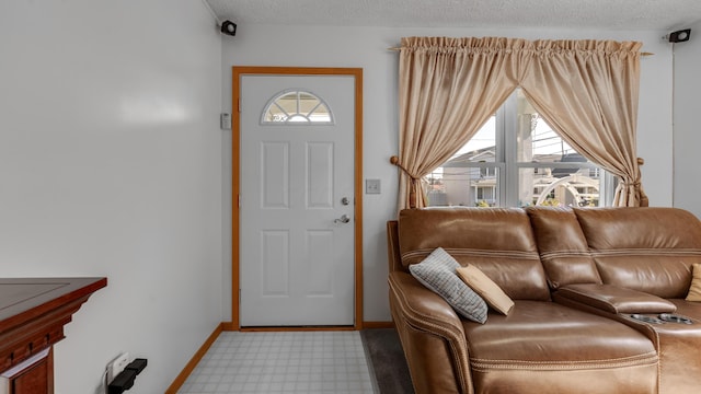 carpeted foyer with a textured ceiling