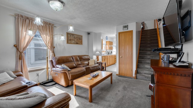 carpeted living room featuring a textured ceiling