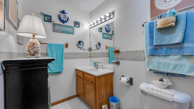 bathroom with vanity, a textured ceiling, and toilet